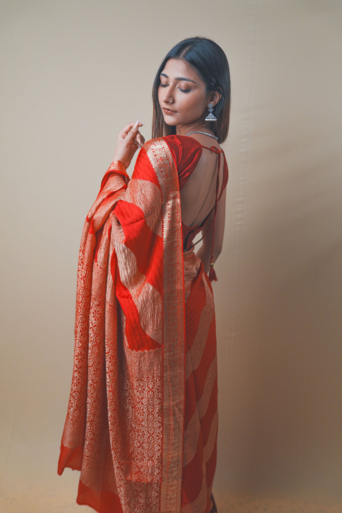 Radiant Red Crepe Silk Saree Featuring Detailed Zari Work