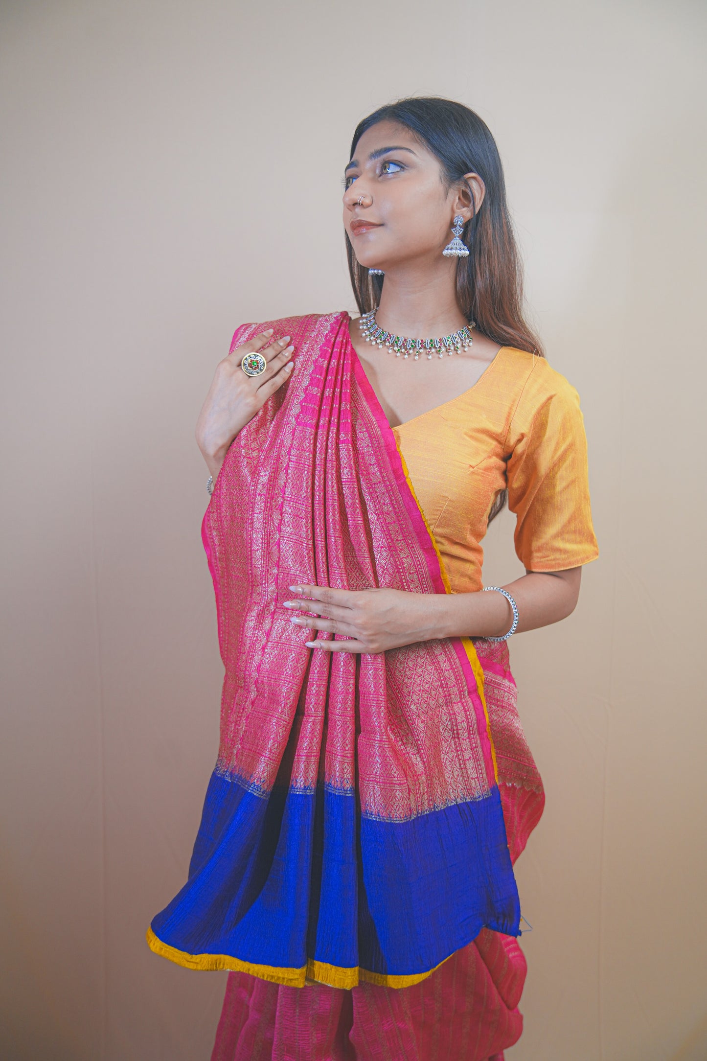 Pink Banarasi Raw Silk Saree with Golden Zari Work and Contrasting Blue-Yellow Border