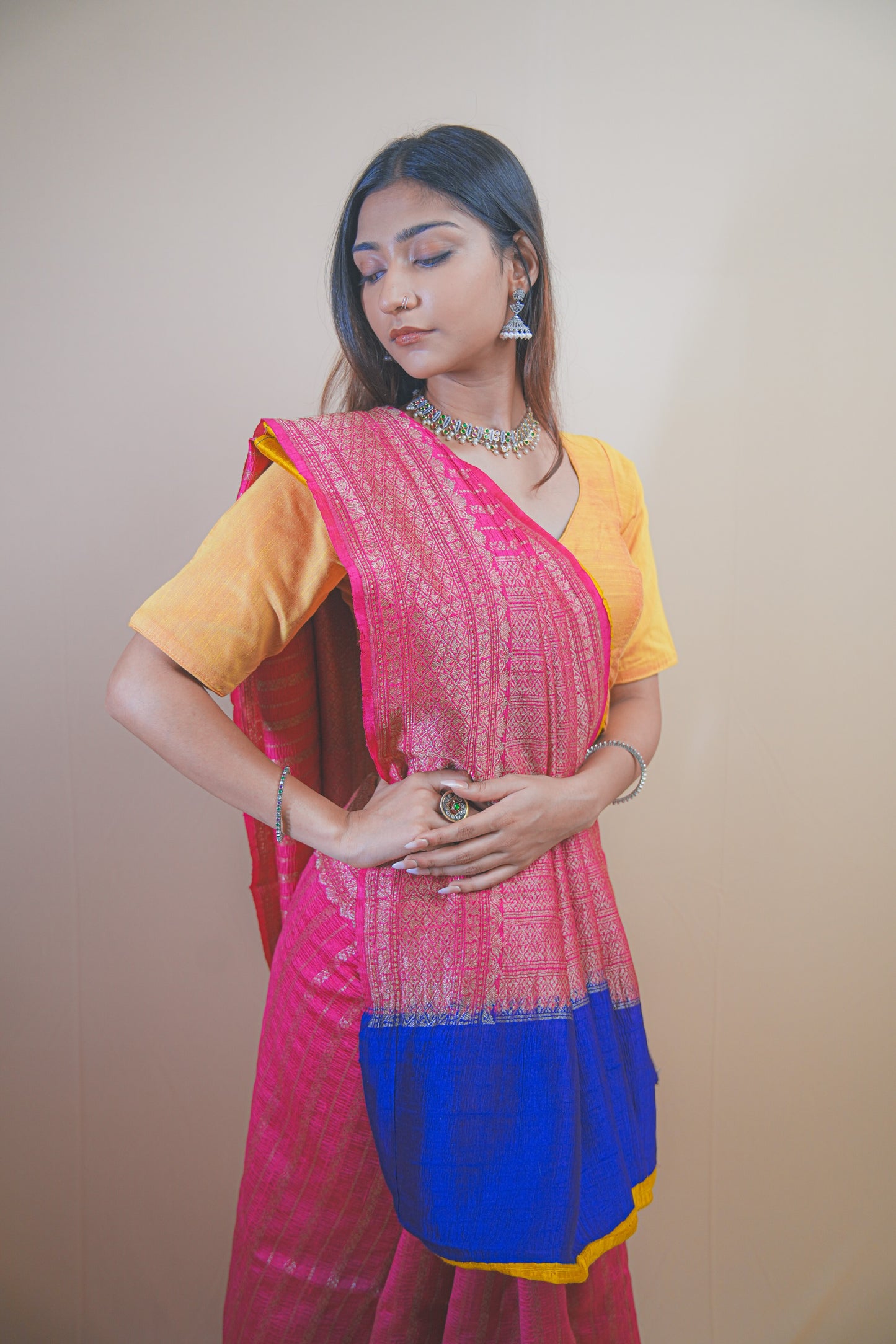 Pink Banarasi Raw Silk Saree with Golden Zari Work and Contrasting Blue-Yellow Border
