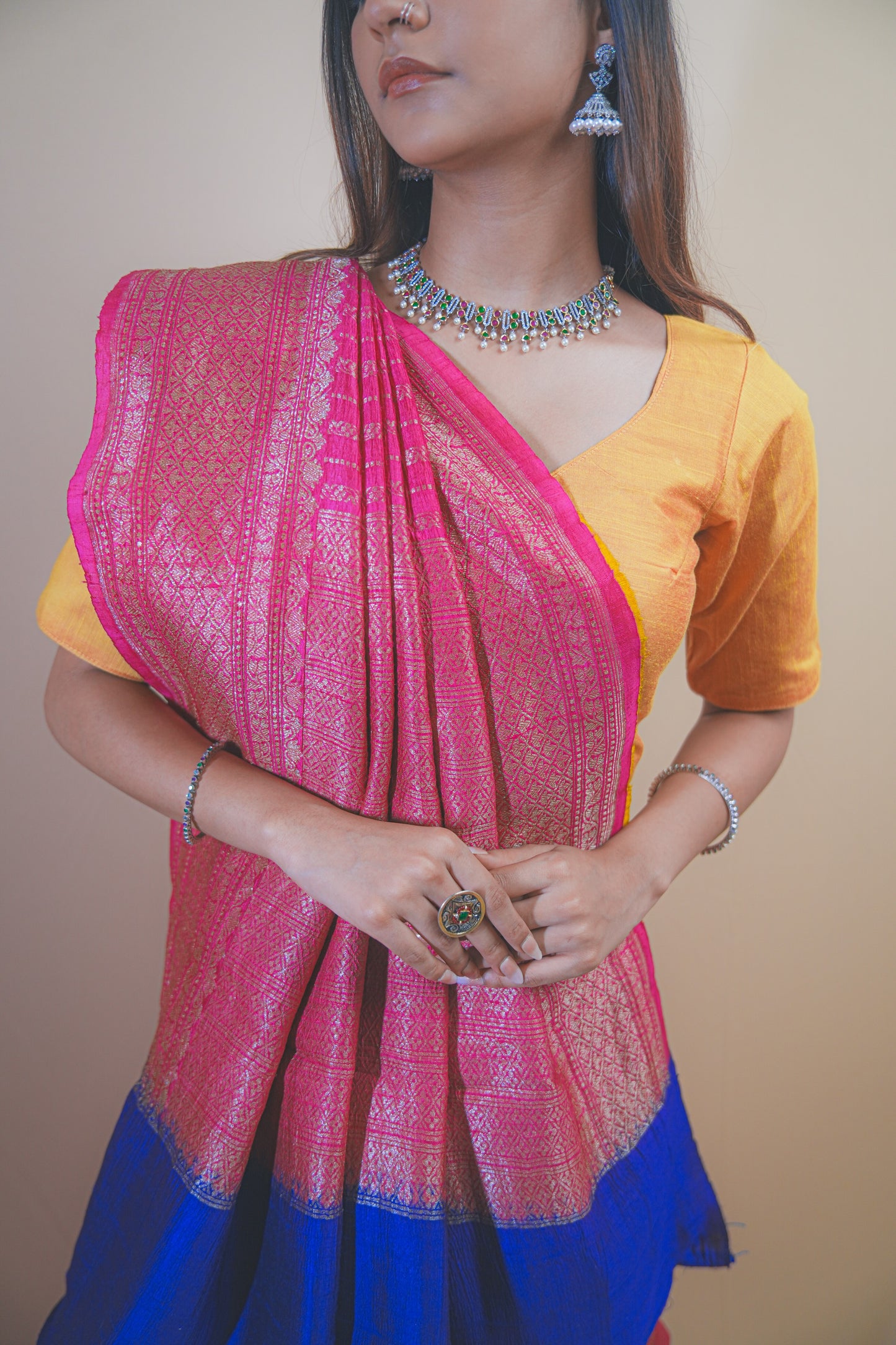 Pink Banarasi Raw Silk Saree with Golden Zari Work and Contrasting Blue-Yellow Border