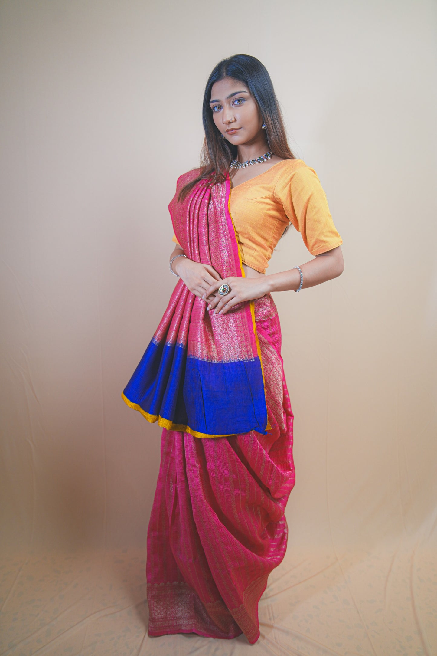 Pink Banarasi Raw Silk Saree with Golden Zari Work and Contrasting Blue-Yellow Border